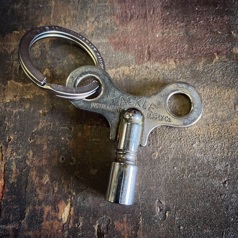 Timekeepers Drum Key from Tackle shown in raw steel unpacked at an old wooden surface